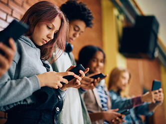 Teenagers looking at phones